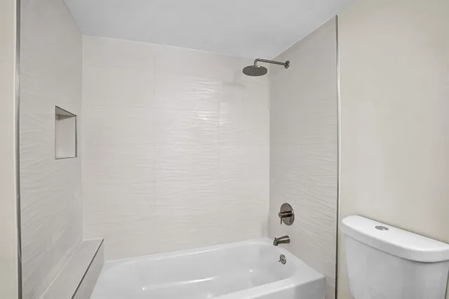 a bathroom with a bathtub and a toilet