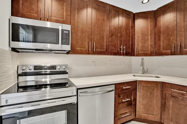 a kitchen with a cabinets and steel stainless steel appliances