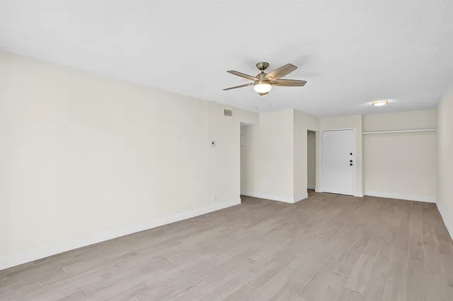 a view of an empty room with a fan