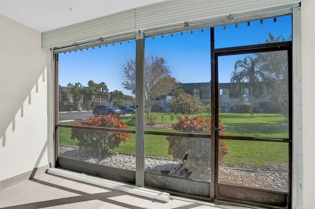 a view of a glass door with a yard from a balcony
