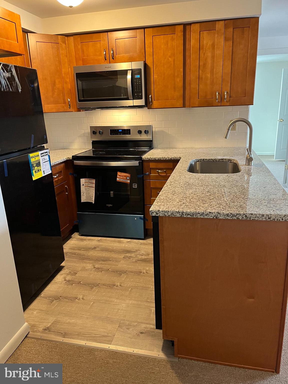 643 Main Street, Unit C3 Pennsburg, PA 18073 - Photo 2 of 11 a kitchen with stainless steel appliances a sink a stove a microwave a counter top space and cabinets