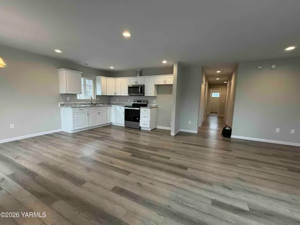 a open kitchen with kitchen island a sink stainless steel appliances and cabinets