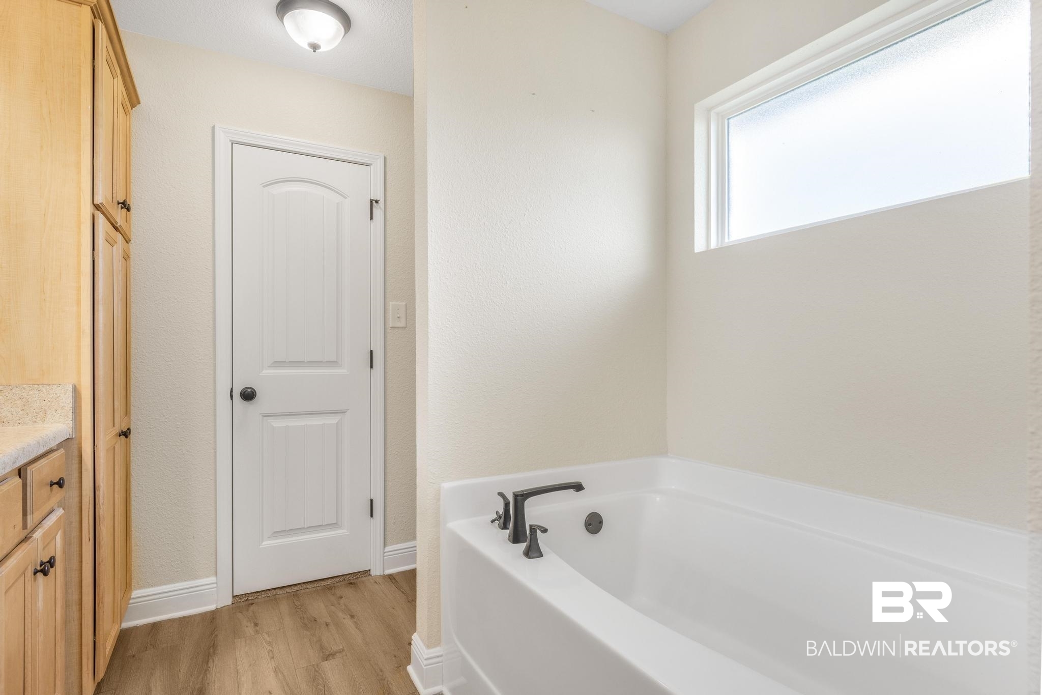 21580 Talbot Lane Robertsdale, AL 36567 - Photo 20 of 25 Bathroom featuring vanity, a garden tub, and light wood-style floors