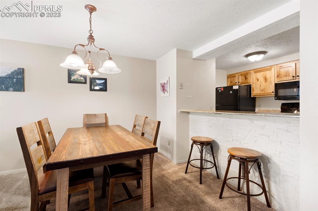 651 Gothic Road, Unit 301 Crested Butte, CO 81225 - Photo 12 of 24 a view of a dining room with furniture and wooden floor