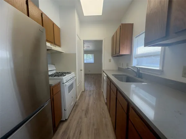 a kitchen with a sink stove and refrigerator