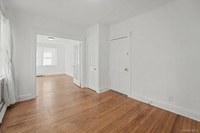 a view of a hallway with wooden floor