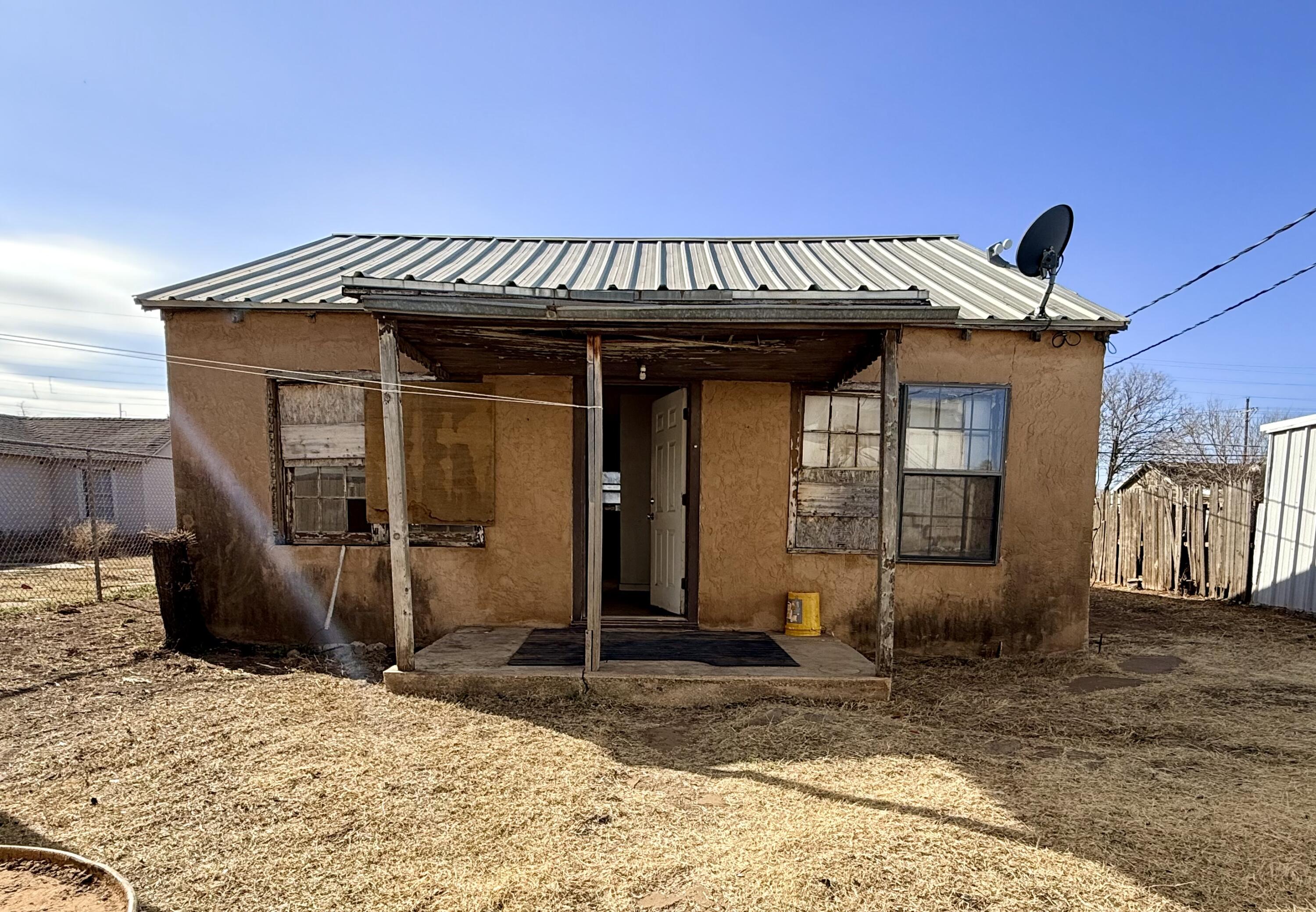 1117 31st Street Lubbock, TX 79411 - Photo 3 of 6 a view of a house with wooden walls