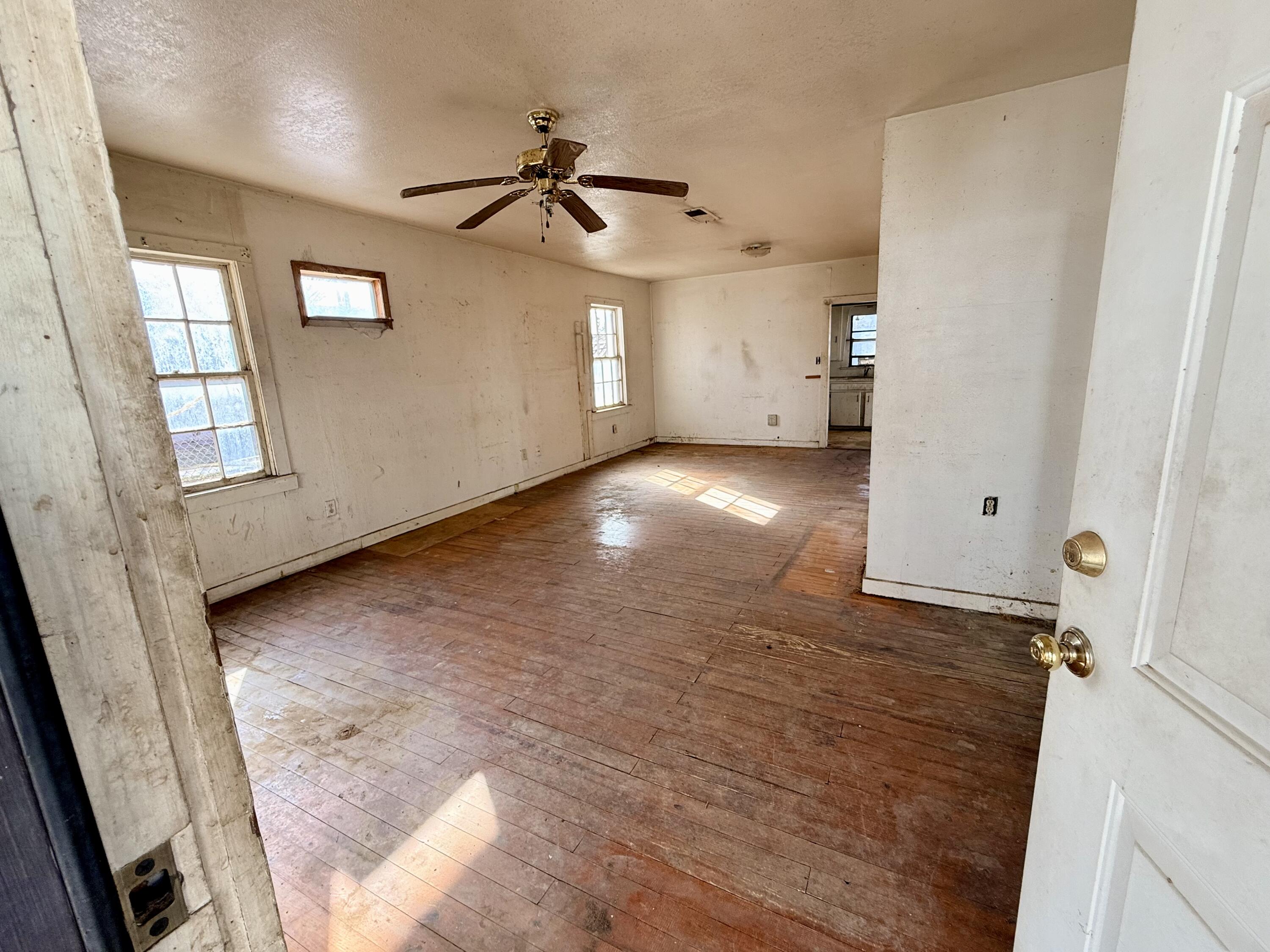 1117 31st Street Lubbock, TX 79411 - Photo 6 of 6 wooden floor in an empty room with a window