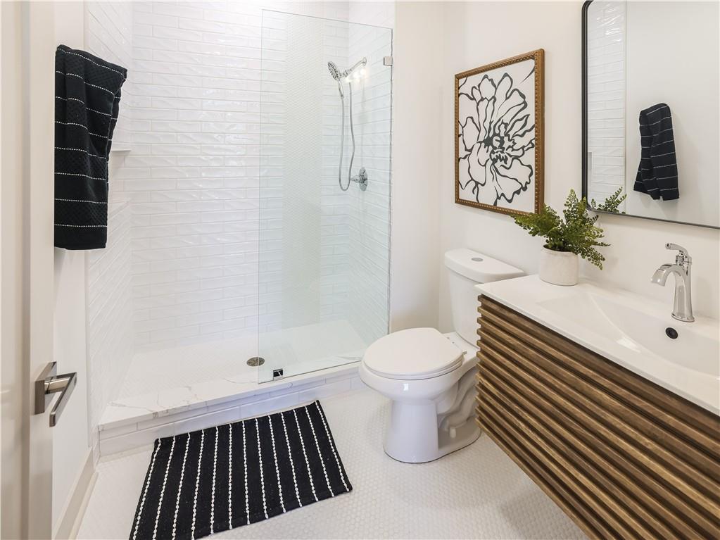 909 Rickenbach Street Pittsburgh, PA 15212 - Photo 11 of 23 a bathroom with a sink and a mirror