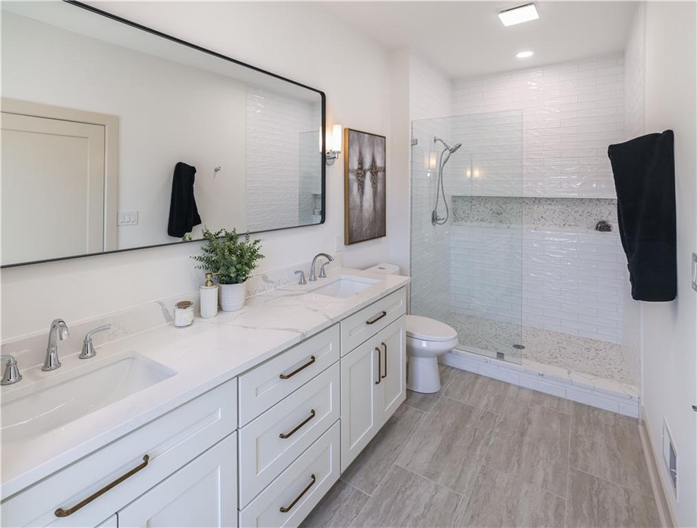 909 Rickenbach Street Pittsburgh, PA 15212 - Photo 13 of 23 a bathroom with a double vanity sink toilet and mirror