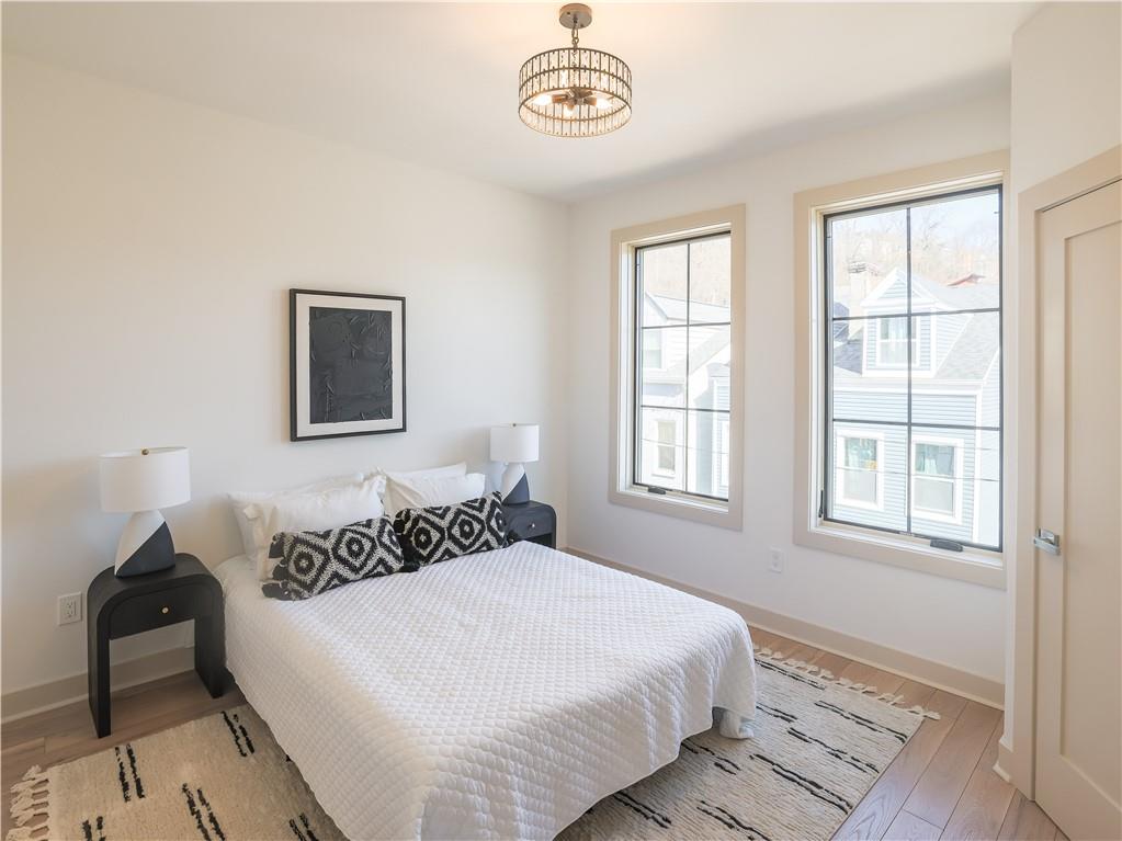 909 Rickenbach Street Pittsburgh, PA 15212 - Photo 14 of 23 a bedroom with a bed and a window