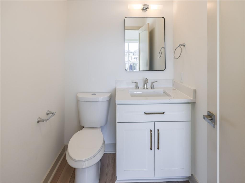 909 Rickenbach Street Pittsburgh, PA 15212 - Photo 17 of 23 a bathroom with a toilet sink and mirror
