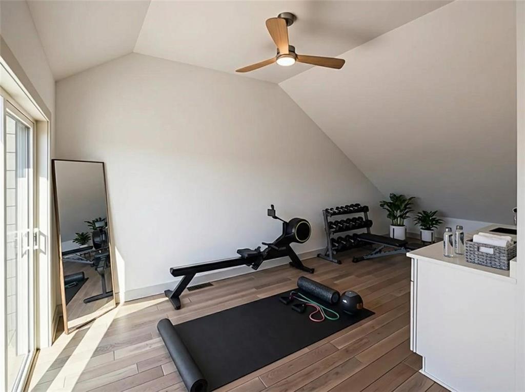 909 Rickenbach Street Pittsburgh, PA 15212 - Photo 18 of 23 a room with gym equipment and a wooden floor
