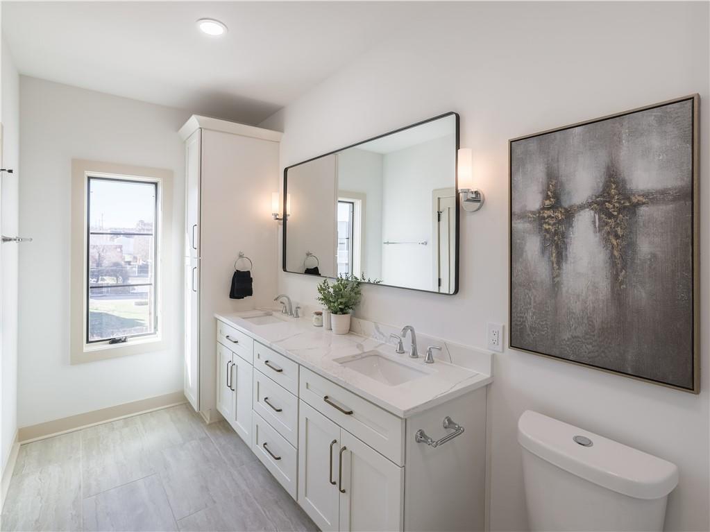 909 Rickenbach Street Pittsburgh, PA 15212 - Photo 20 of 23 a spacious bathroom with a double vanity sink a mirror and a shower