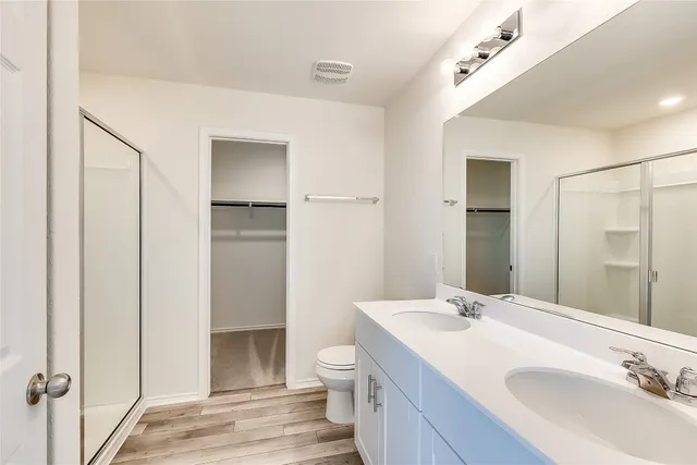 a bathroom with a sink toilet and shower