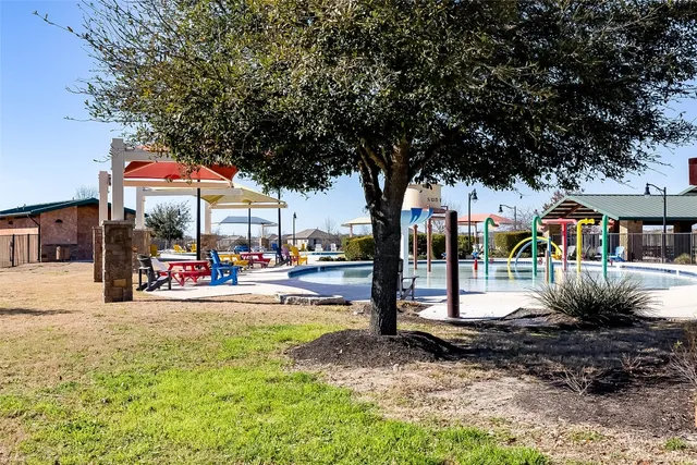 a view of a park with swings and slides