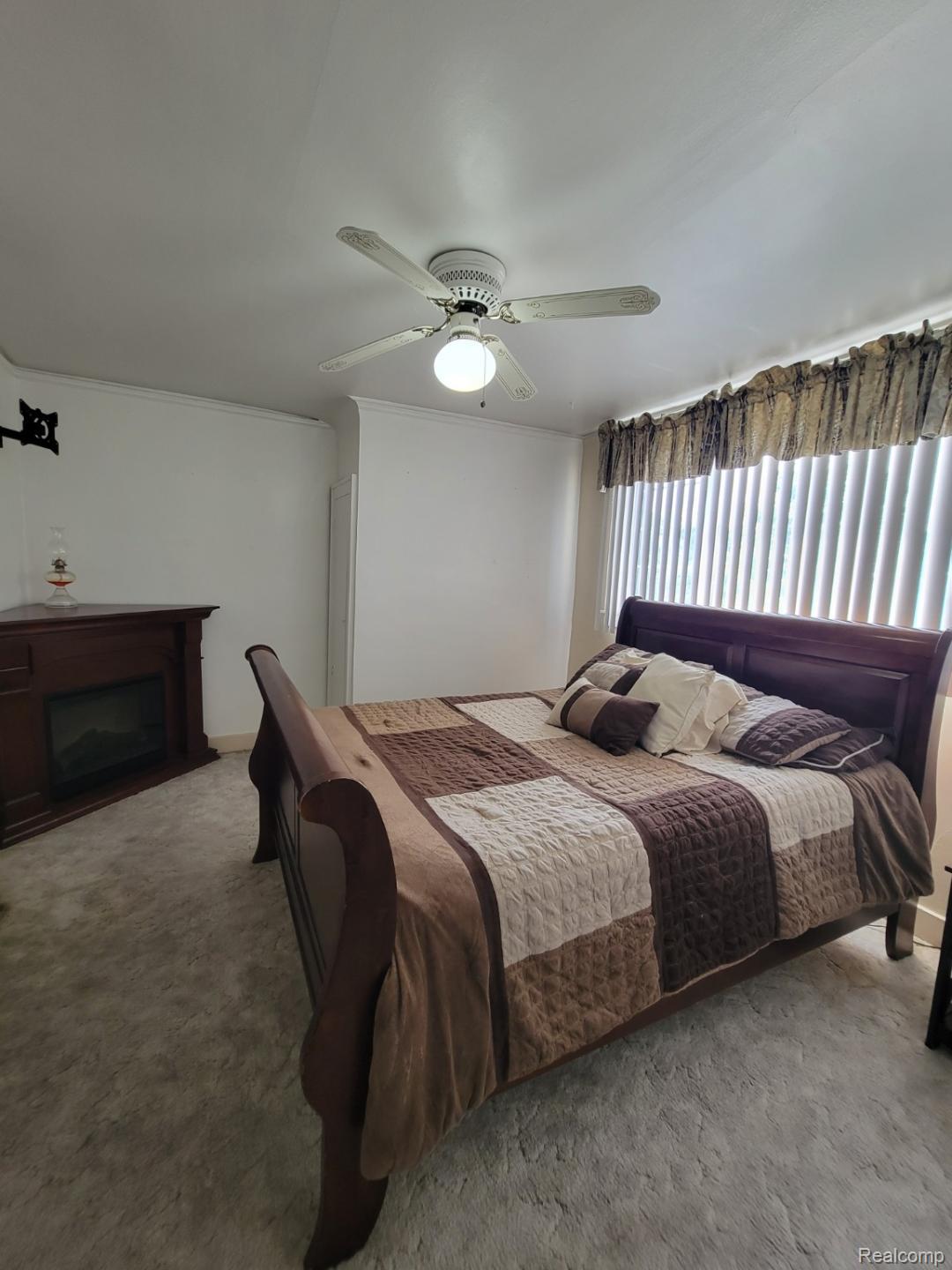 11227 Rivard Avenue Warren, MI 48089 - Photo 23 of 44 Room featuring light grey carpet flooring, white walls, and a ceiling fan with integrated lighting