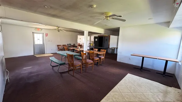 a view of a dining room with furniture and chandelier