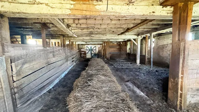 en empty room with wooden floor and windows