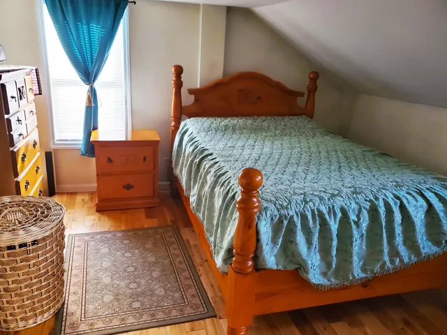 a bedroom with a bed and a window