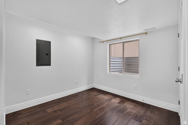 2223 North Pointe Meadow Loop Lehi, UT 84048 - Photo 36 of 56 Interior room featuring dark wood-finish flooring, white baseboards, and bright white walls