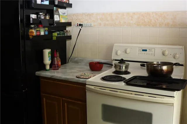 a room with a wooden floor and cabinets