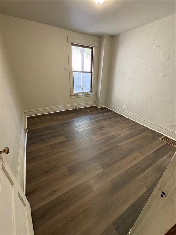 518 Middle Avenue Wilmerding, PA 15148 - Photo 32 of 37 an empty room with wooden floor and windows
