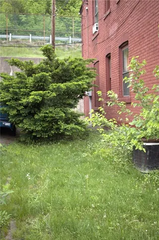 a backyard of a house with lots of green space and fountain