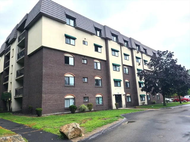 a front view of a building with a yard