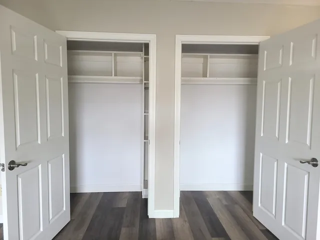 a view of walk in closet with wooden floor