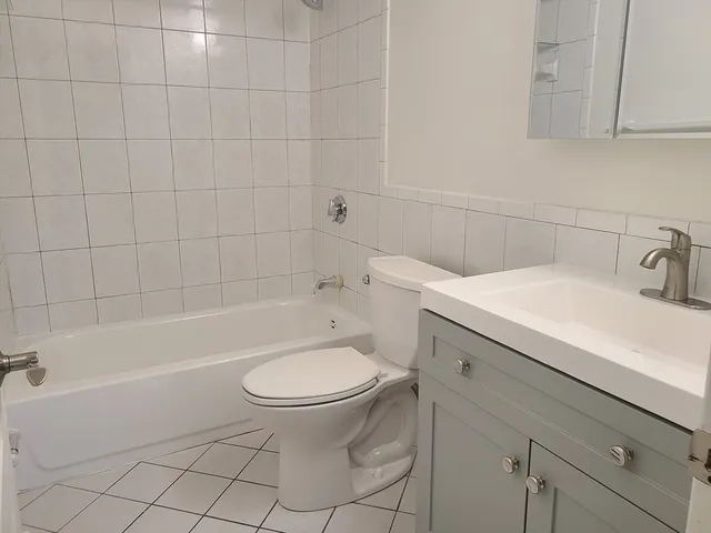 a bathroom with a sink a toilet and bathtub