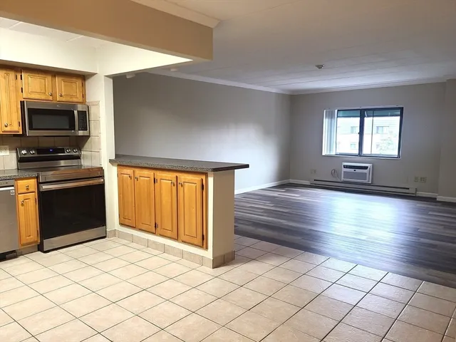 a kitchen with granite countertop a stove cabinets and microwave