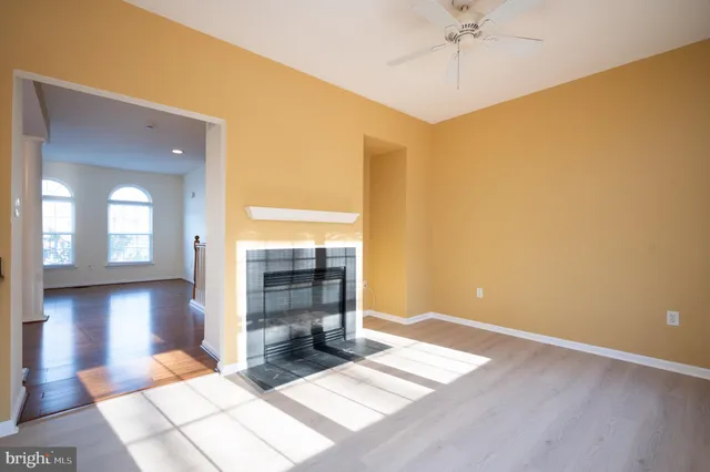 a view of empty room with a window and chandelier