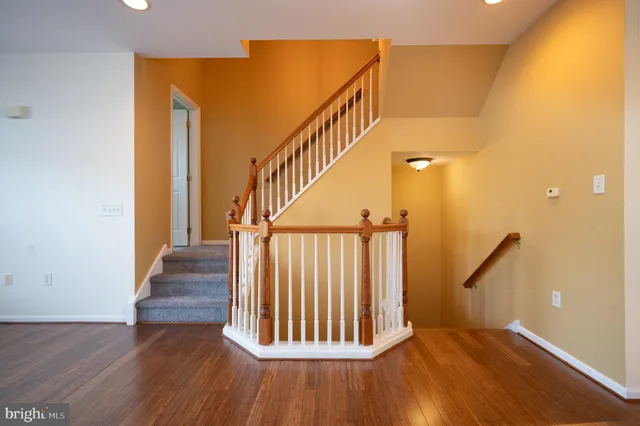 a view of a room with wooden floor and windows