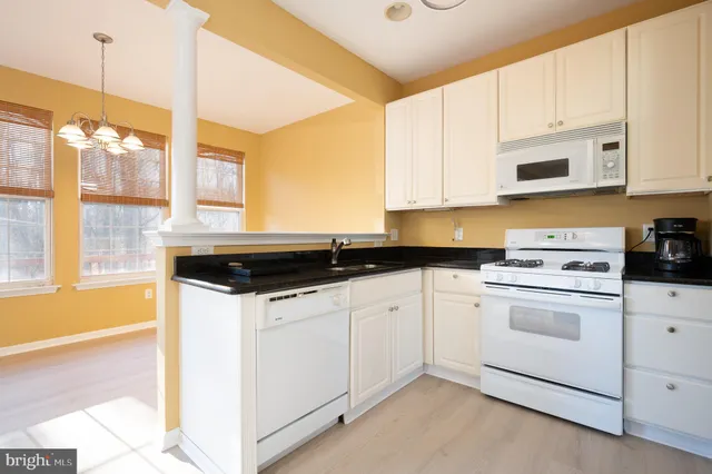 a kitchen with granite countertop a sink and a stove