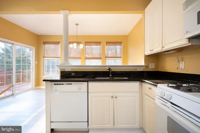 a kitchen with granite countertop a sink and a window