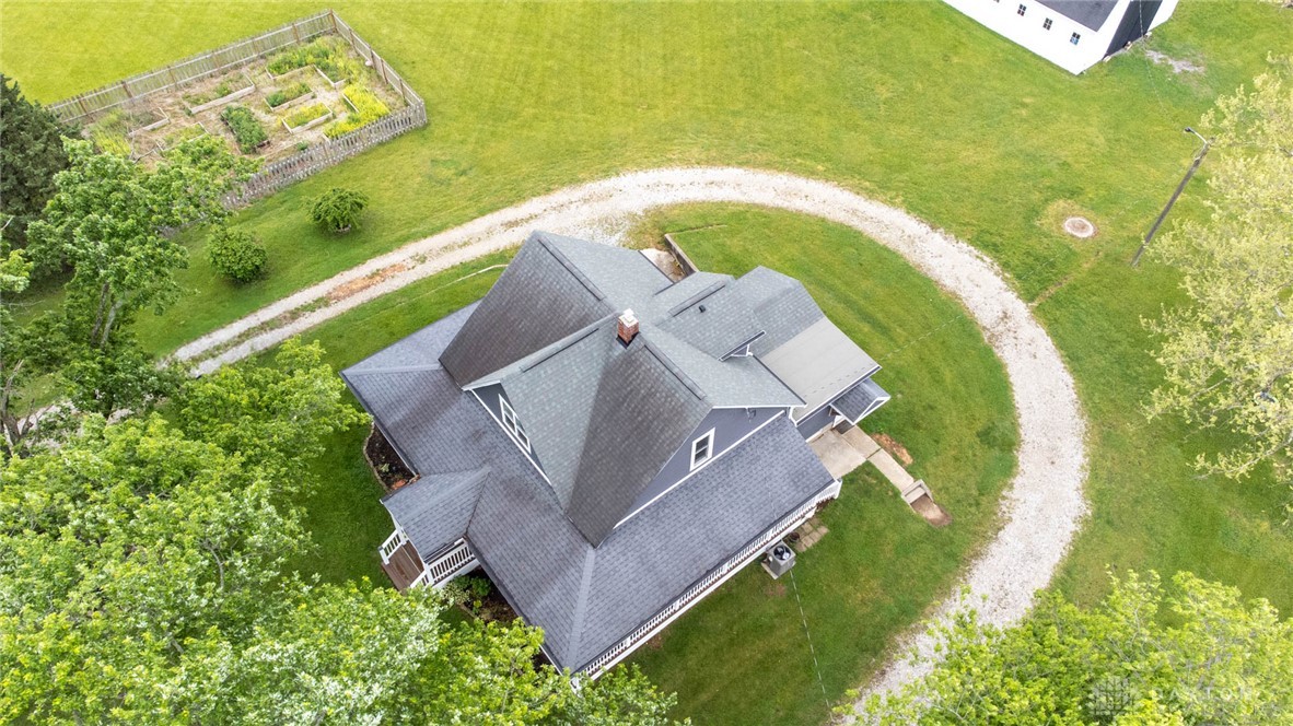 190 Swailes Road Troy, OH 45373 - Photo 53 of 82 This elevated view captures a charming residence surrounded by lush green landscape and a winding gravel driveway.