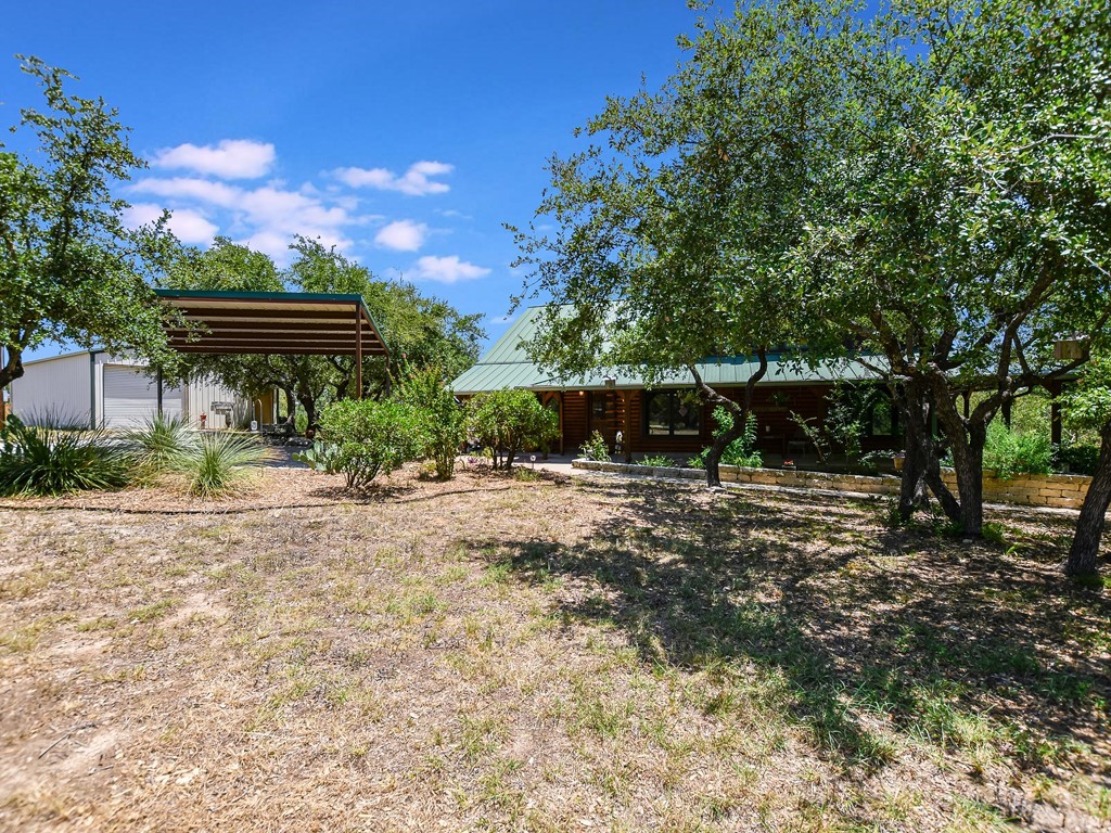 254 Middleton Road Spicewood, TX 78669 - Photo 24 of 32 a view of a house with a yard and tree s