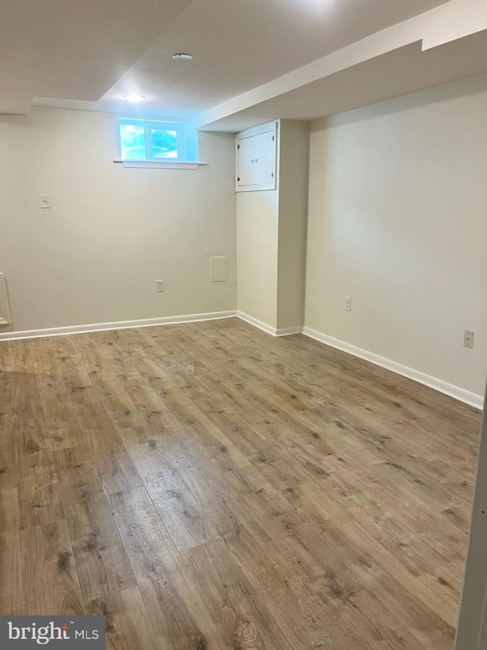 362 Ripka Street, Unit A Philadelphia, PA 19128 - Photo 15 of 18 an empty room with wooden floor and windows