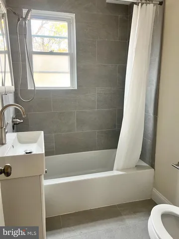a white bath tub sitting next to a white sink