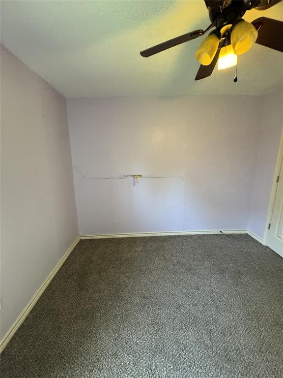 803 Ripley Avenue Ennis, TX 75119 - Photo 19 of 40 Room featuring a ceiling fan with light fixture, textured carpeting, and baseboard trim