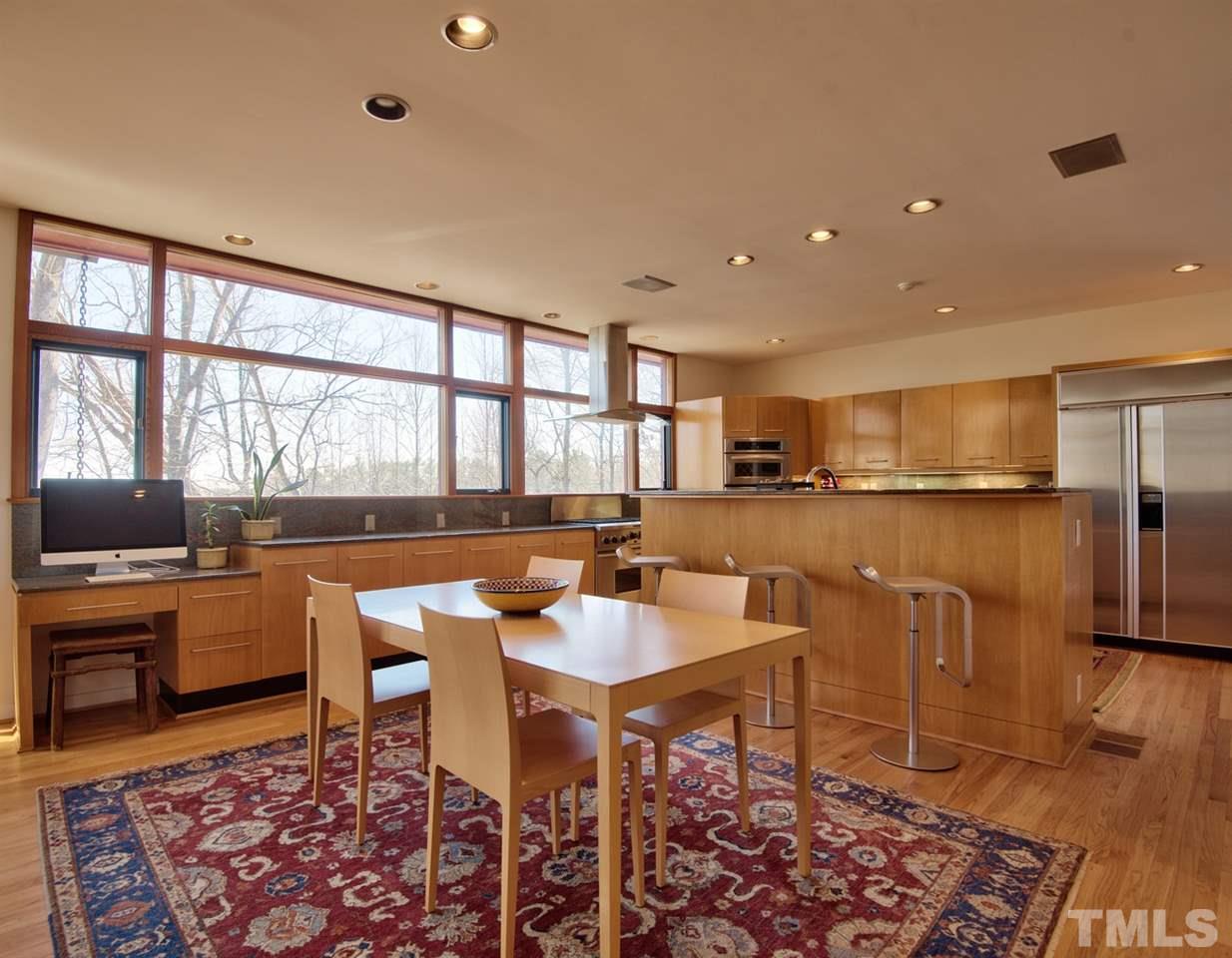 55219 Broughton Chapel Hill, NC 27517 - Photo 11 of 25 a living room with furniture a rug and a floor to ceiling window
