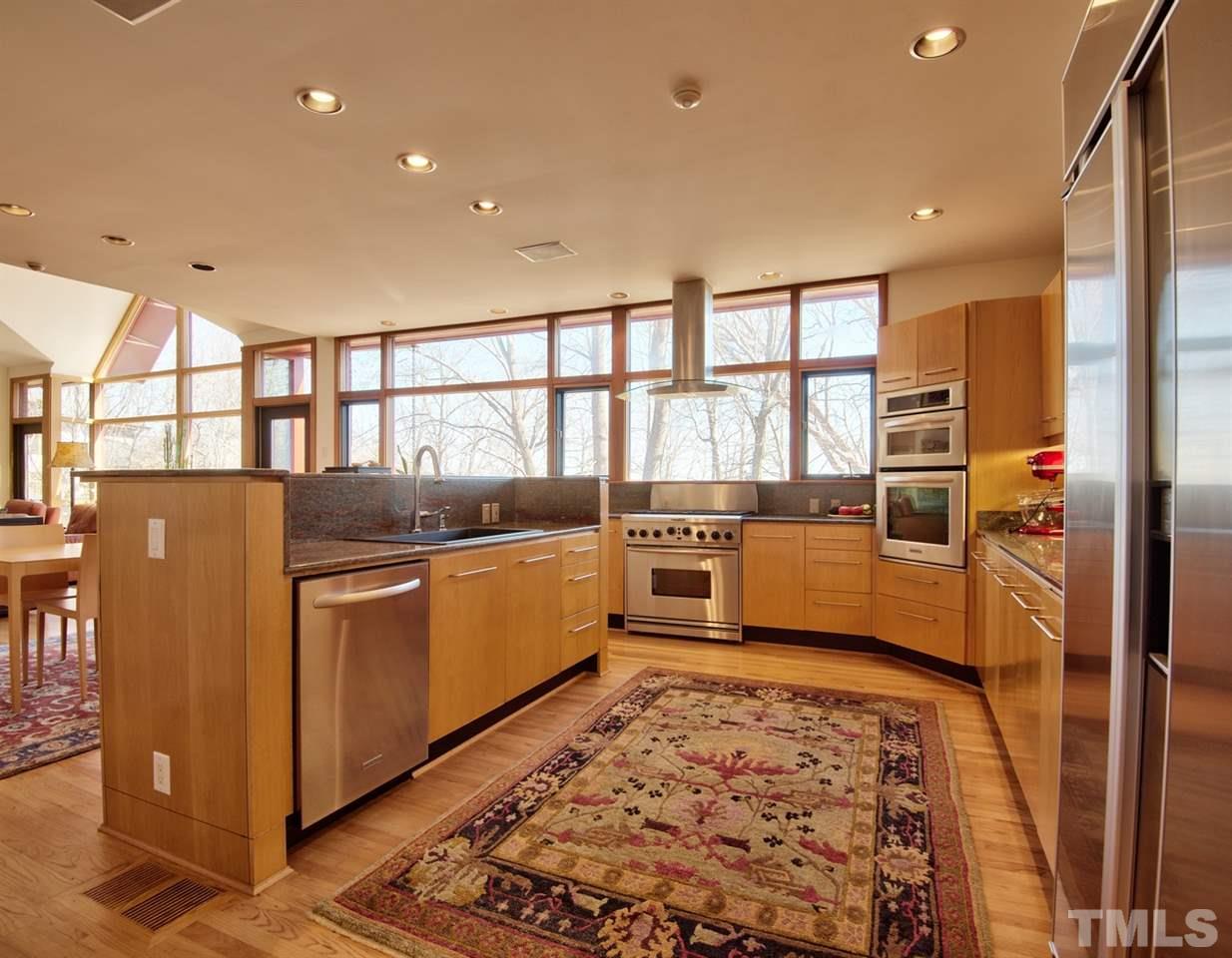 55219 Broughton Chapel Hill, NC 27517 - Photo 12 of 25 a kitchen with stainless steel appliances granite countertop a refrigerator and a sink