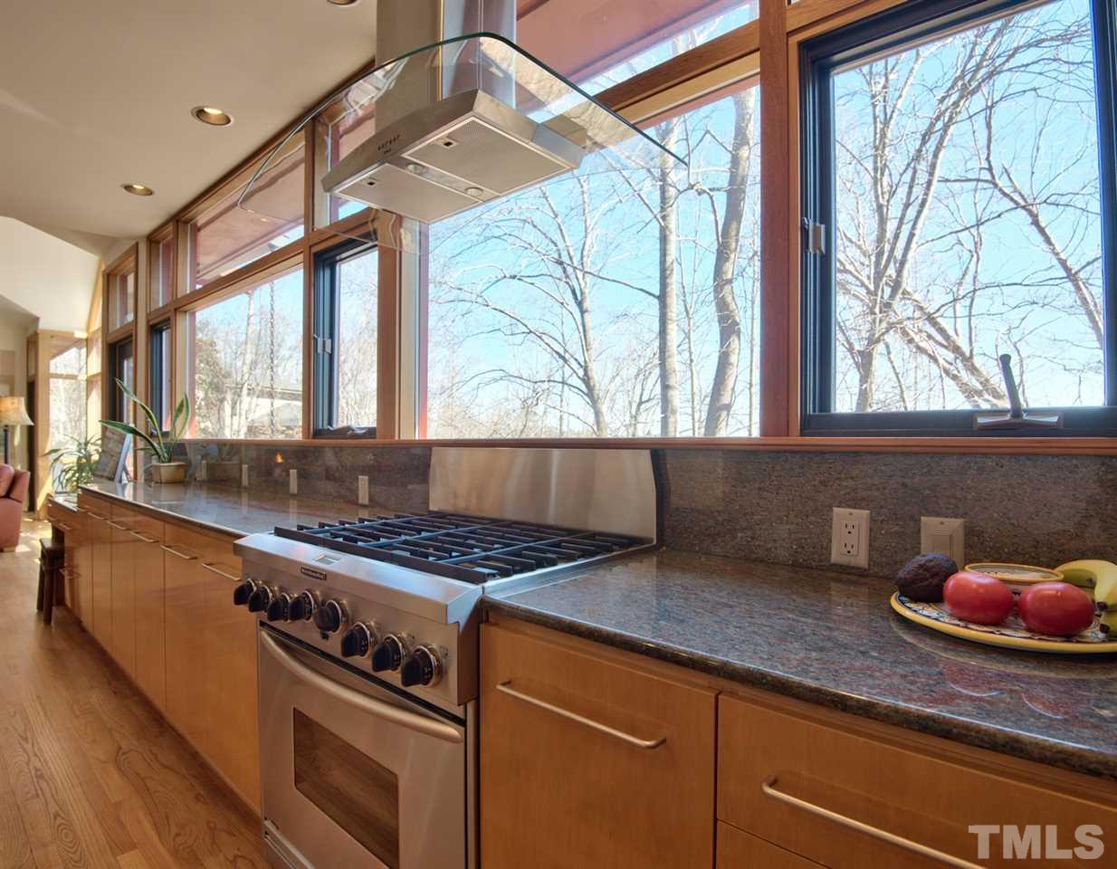 55219 Broughton Chapel Hill, NC 27517 - Photo 14 of 25 a kitchen with a stove a sink and a window
