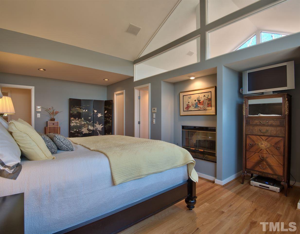 55219 Broughton Chapel Hill, NC 27517 - Photo 16 of 25 a bedroom with a bed and a flat screen tv