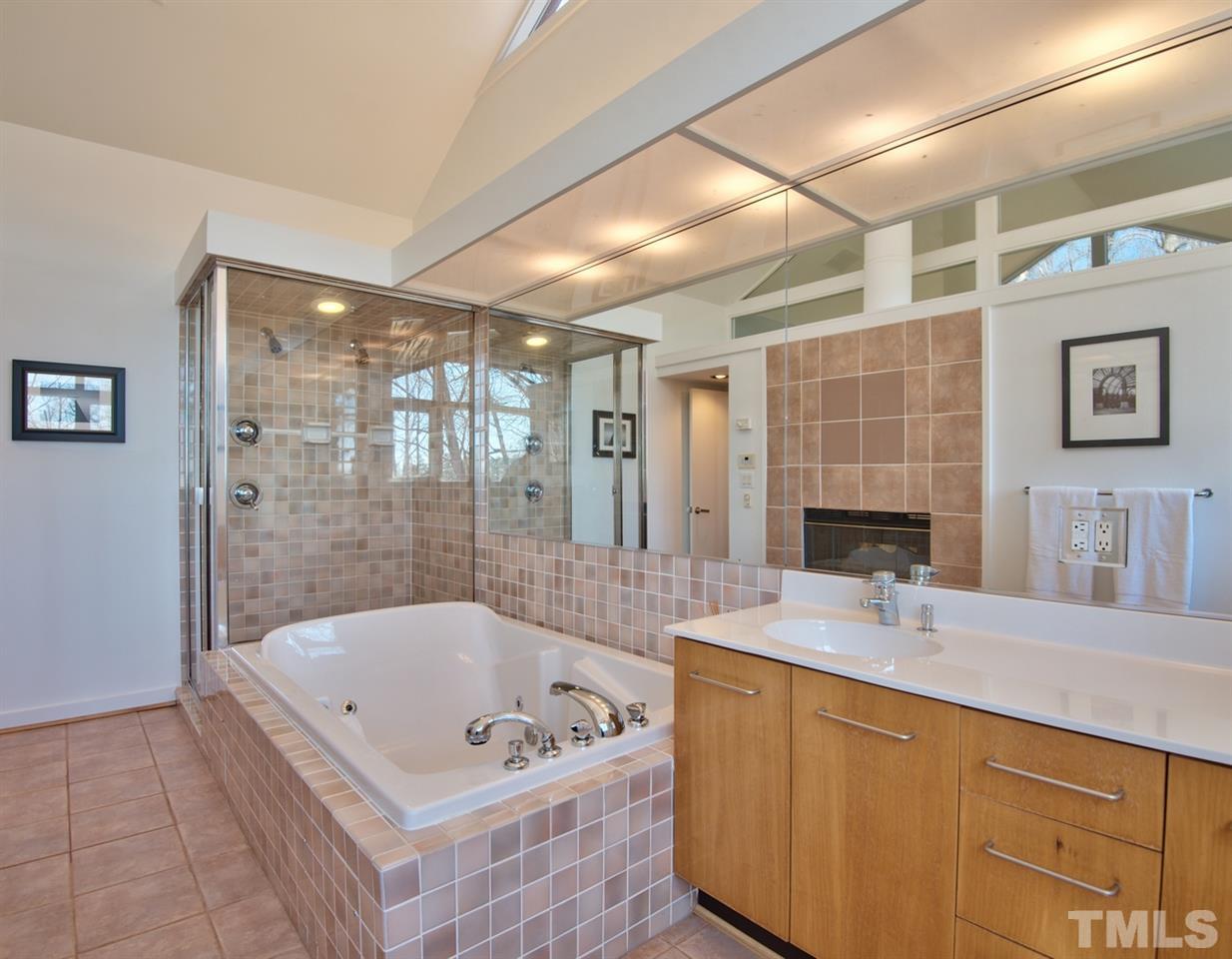 55219 Broughton Chapel Hill, NC 27517 - Photo 17 of 25 a bathroom with a tub sink and mirror