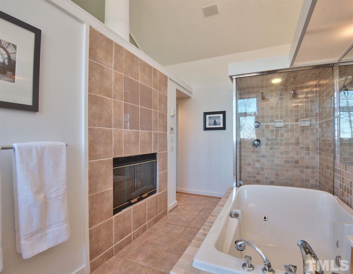 55219 Broughton Chapel Hill, NC 27517 - Photo 18 of 25 a bathroom with a tub a sink and a shower