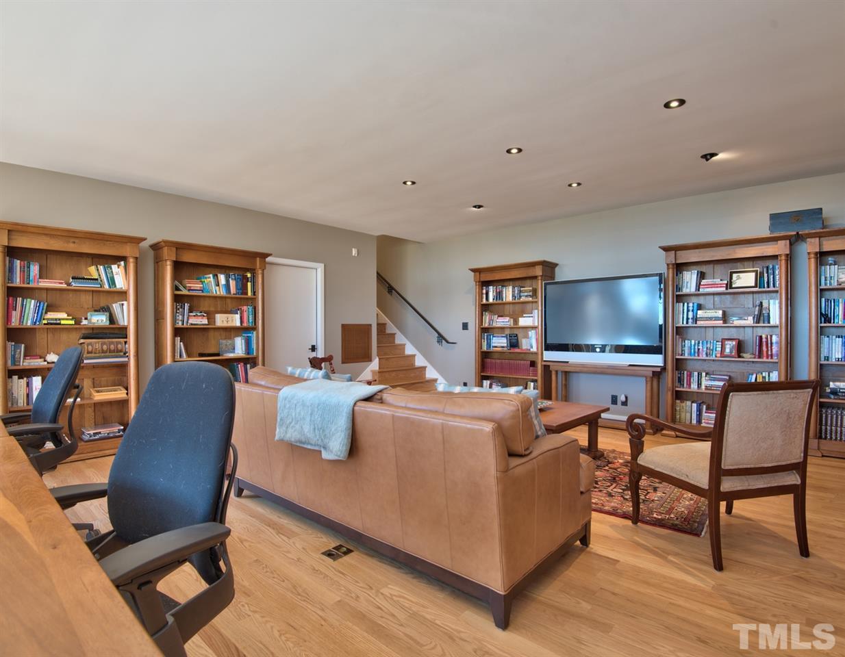 55219 Broughton Chapel Hill, NC 27517 - Photo 20 of 25 a living room with furniture and a bookshelf