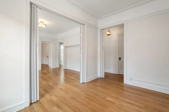 a view of a room with wooden floor