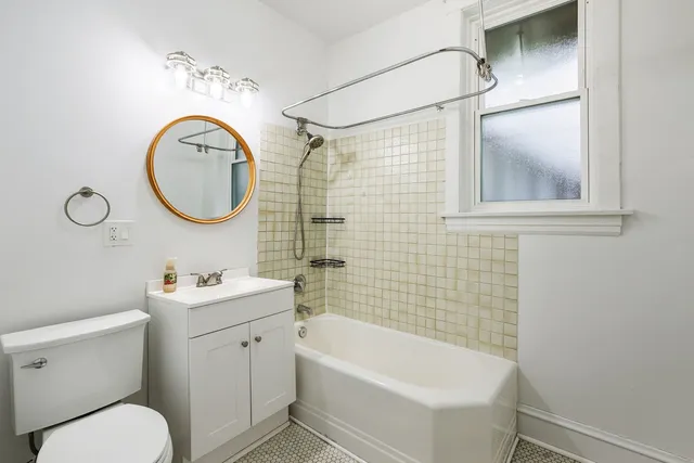 a bathroom with a sink a toilet and a mirror